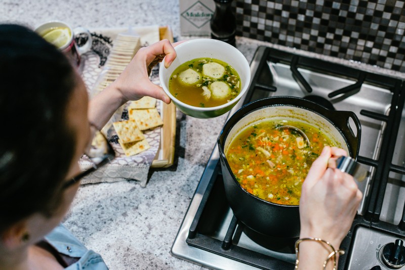 Jordan serving chicken soup.