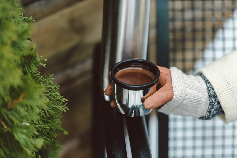 Woman pouring hot chocolate from vacuum flask