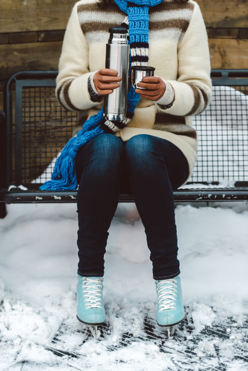 Woman pouring hot chocolate from vacuum flask